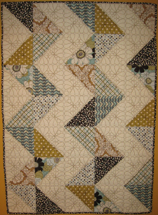 There are 2 embroidery options with the Raising Daisies design! This is the Alayna quilt done in a zigzagged layout. There are so many options with this design.